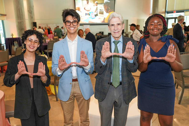  At the Scholarship Donor Celebration event, from left, Grecia Rivera, Ethan Tieu, University President Julio Frenk and J’Nesse Balkman. Photos: Dan Perez Photography for the University of Miami 