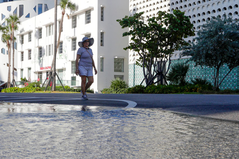 A woman walks along a flooded street in Miami Beach caused by a king tide on Sept. 28, 2019. Photo: The Associated Press