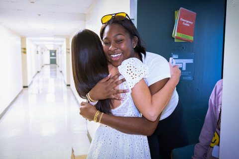   Mikah Finley, from Plano, Texas, right, embraces her new friend, Willow Egan from Providence, Rhode Island, while moving in to their residential college on Wednesday. The first year students met online after deciding to attend the University. Photo: Joshua Prezant/University of Miami
