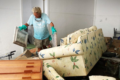   A resident of Sanibel Island in Southwest Florida cleans up her home following Hurricane Ian last fall. Photo: The Associated Press